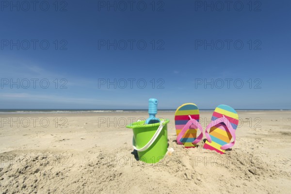 Summer beach with toys and flip flops
