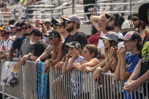 Fans watch as drivers race for position for the Crayon 301 at the New Hampshire Motor Speedway in Loudon NH