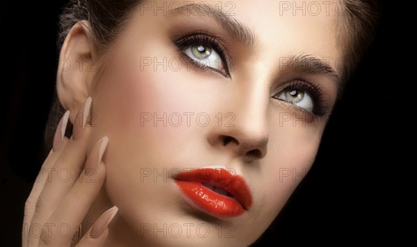 Beautiful facial shot of a female model with expressive eyes and red lips