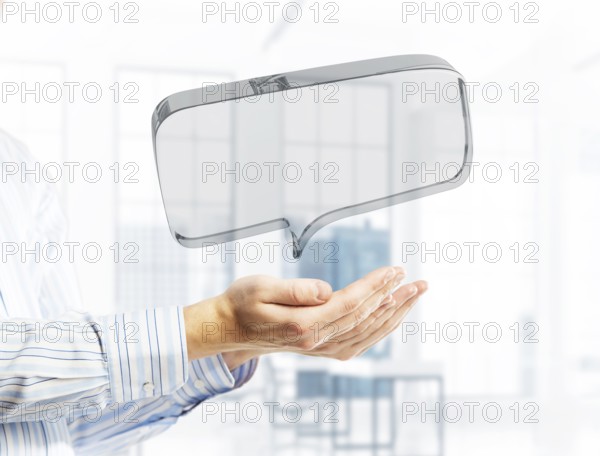 Close of businessman hands showing glass speech bubble as internet concept. Mixed media