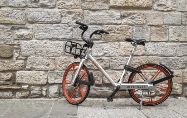 Mobike bicycle meant for bike sharing, parked in public area. Mobike a popular bike sharing platform where users grab bikes through an app in many places in Italy and in the world. Bergamo, ITALY - December 6, 2018
