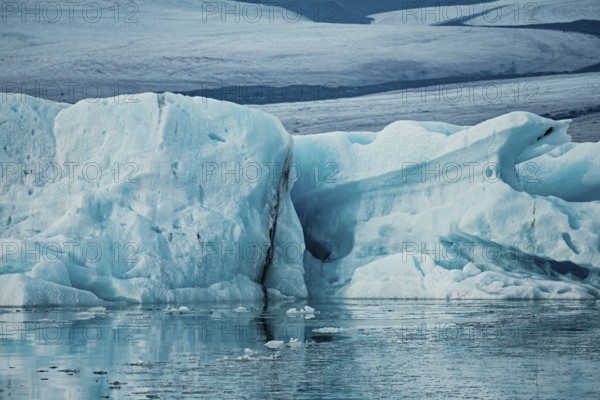 Large ice formations in a serene icy landscape with reflections on water, iceberg, glacier, snow, ice rock, ice diamont, glacier lagoon, nature, snow, diamont beach, Iceland, Europe