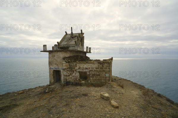 Autumn morning and mountain landscape by the sea, old lighthouse on the cliff