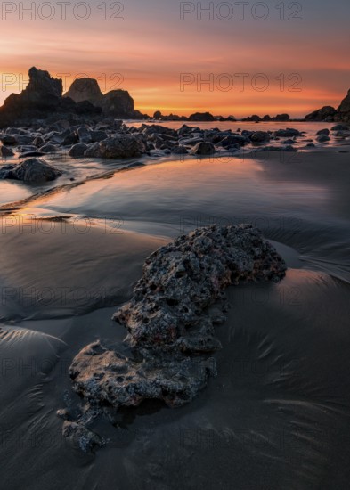 This is a color landscape photo of a vivid sunset over the Pacific Ocean