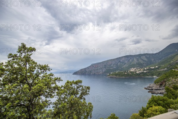Coastal landscape shot. View from a road leading along the sea and through a breathtaking green Mediterranean landscape. Coast near Salerno, Italy, Europe
