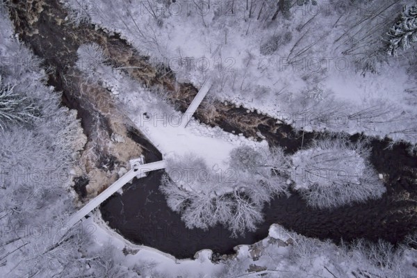 Aerial view of winter river landscape, snow covered branches, trees and ground, Nukarinkoski, Nurmijärvi, Finland, Europe