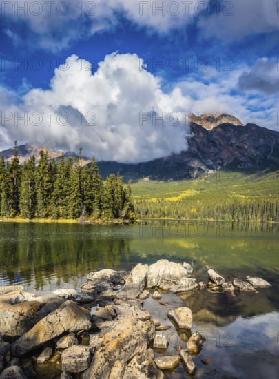 Transparent autumn morning in Jasper National Park, Canada. The woody small island in Pyramid Lake