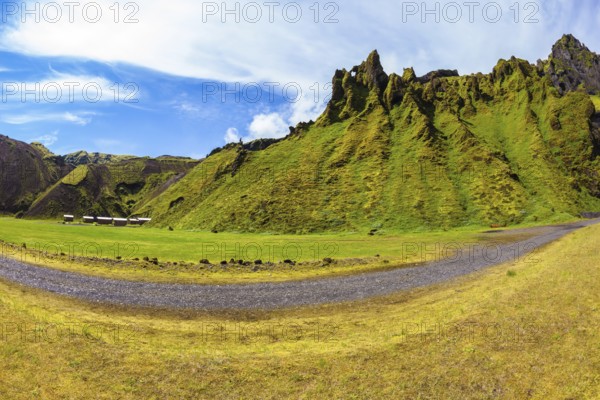 The photo was taken Fisheye lens. Camping in the canyon Pakgil, Iceland. The canyon - green grass and moss on fantastic rocks. On canyon there is dirt road