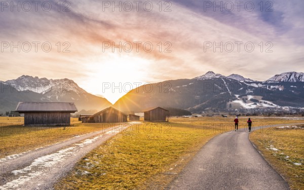 Winter landscape with mountain village in the Austrian Alps, wooden barns and country roads, at sunset. Perfect decor for an evening run