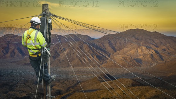 Lineman (Or Lineworker or Engineer) In A Remote Desert Landscape Fixing A Telephone Line