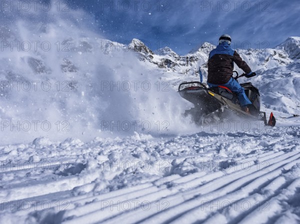 Snowmobile on a trail in the Italian alps