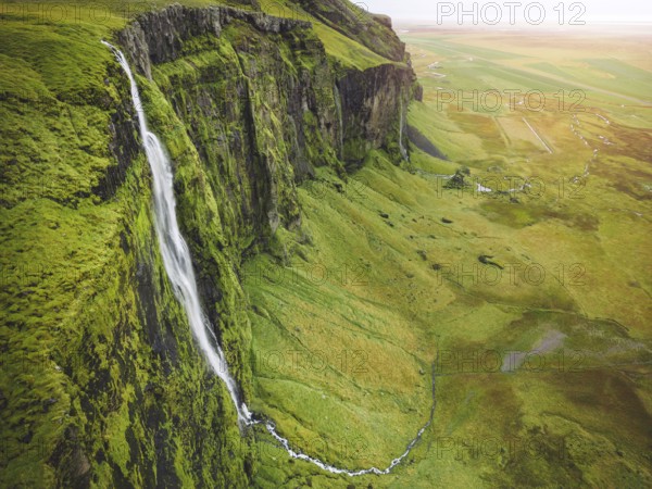 Iceland waterfall nature travel landscape in Icelandic nature background. Popular tourist attraction summer holiday destination in on South Iceland.