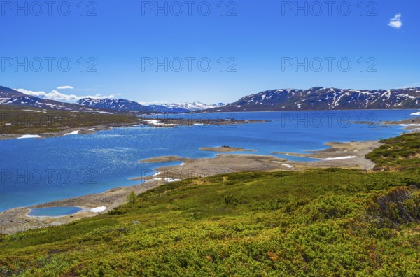 Amazing Vavatn lake panorama rough landscape view rocks boulders and mountains during summer in Hemsedal Norway