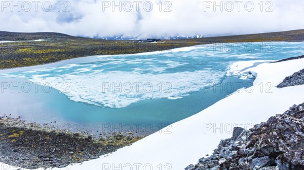 Galdhøpiggen snow-covered in summer in Jotunheimen Lom in Norway is the largest and highest mountain in Norway and Scandinavia with 2469 meters