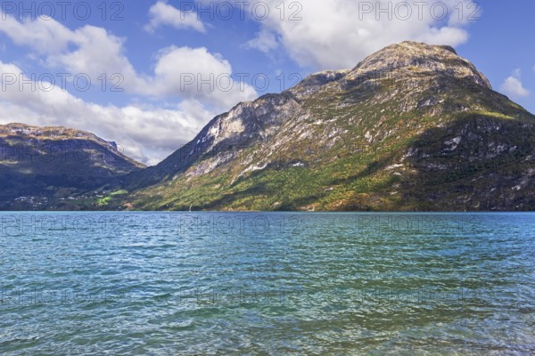Gerbirgs lake Oppstrynsvatnet in Norway. The greenish-blue colour is caused by clay particles from the nearby Jostedalsbreen glacier. Mountain lake Oppstrynsvatnet (or Oppstrynsvatn) in Stryn, Norway, Europe. The blue greenish colour of the water is caused by clay from the nearby Jostedalsbreen glacier, Europe