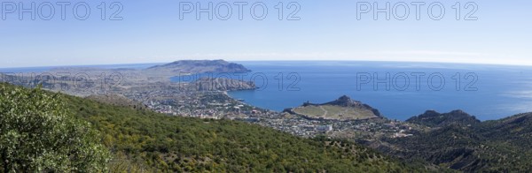 Panorama of the Black Sea coast, a view from the Perchem mountain on the resort town of Sudak and Kapselsky bay. Crimea. Sunny day in September