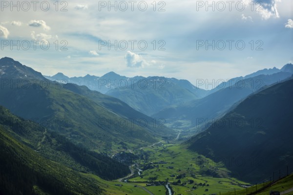 Beautiful Panoramic View over the Golf Course with Mountainscape and in a Mountain Valley in a Sunny Summer Day in Andermatt, Uri, Switzerland, Europe