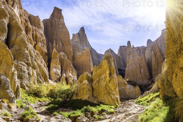 Grandiose natural land formations - Clay Cliffs. Jagged sharp pinnacles and ridges separated by narrow ravines. New Zealand, South Island. The concept of extreme, natural and photo tourism