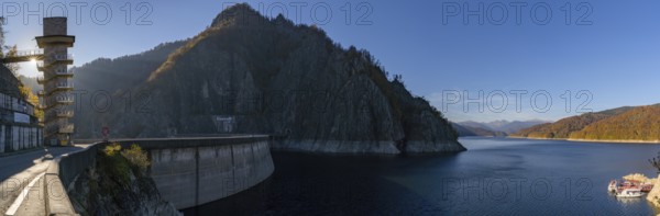 A panorama view of the Lake Vidraru reservoir and dam in the Fagaras mountains of central Romania