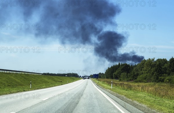 A big fire in the forest near the highway