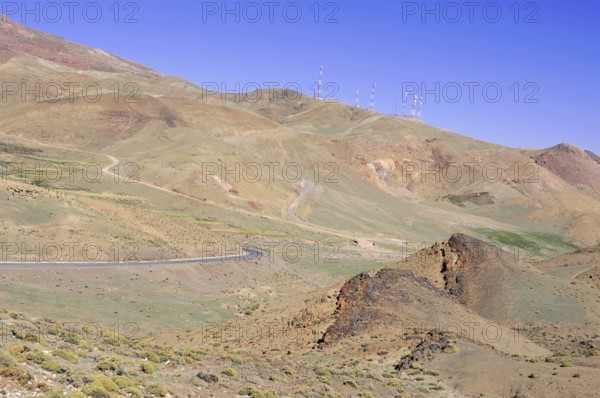Tichka Pass, Col du Tichka, 2260m, Dry hilly landscape with a road and antenna structures under a blue sky, At the Tichka Pass, Col du Tichka, 2260m, Morocco, Africa