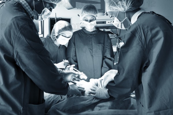 Surgery team operating in a surgical room