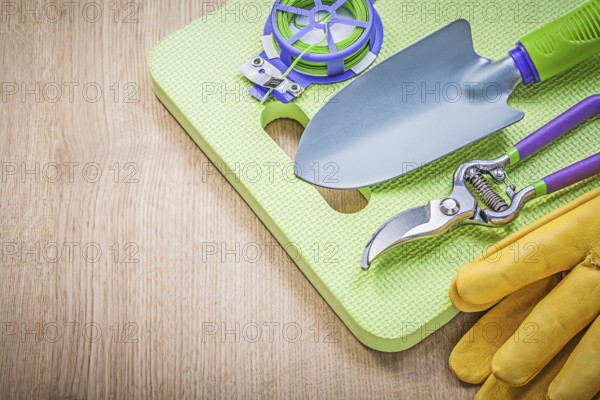 Composition of farming tools on wooden board gardening concept