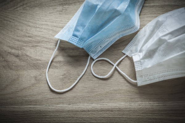 Disposable surgical mask on wooden board