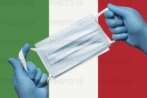 Medic holding respiratory face mask in hands in blue gloves on background flag of Italy or Italian Tricolour. Concept coronavirus quarantine and pandemic outbreak. Medical bandage for human face
