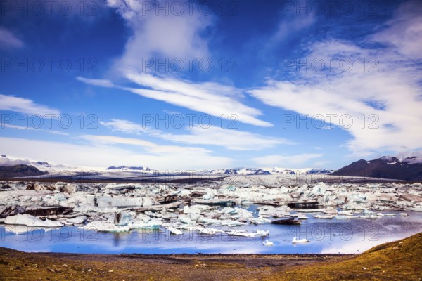 Sunrise in the Ice Lagoon. Drift ice Ice Lagoon - Jokulsarlon. Ice floes are reflected in the smooth water surface. The concept of extreme northern tourism