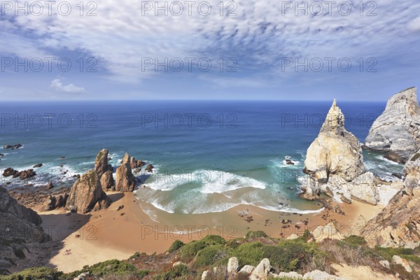 Atlantic coast of Portugal. Two picturesque cliffs of white sandstone cliffs of red sandstone on the sides of a small secluded beach