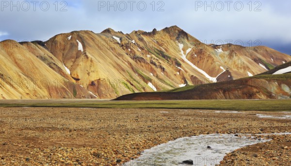 Gorgeous orange and pink mountains. Reserve Landmannalaugar, Iceland. The route starts on a stream
