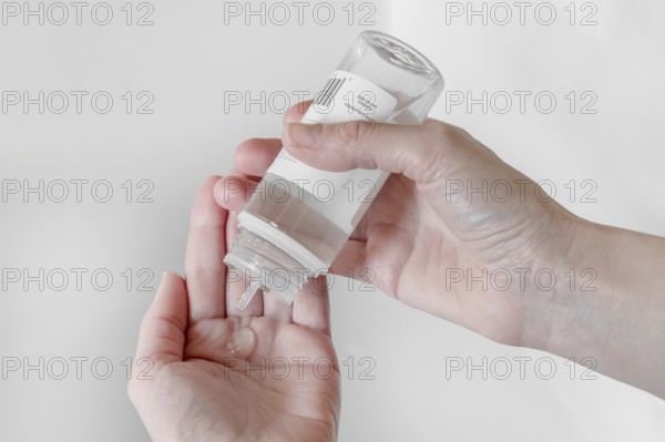 Hand sanitizer gel. Disinfecting hands. Taking disinfection alcohol gel on hands to prevent virus epidemic. Prevention of flu disease. COVID-19. Coronavirus. Cleaning and disinfecting hands in proper way