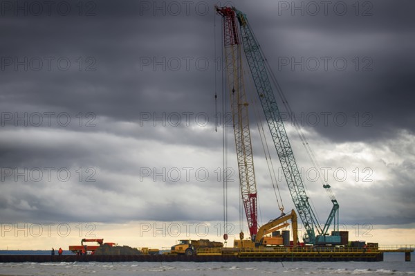 Construction of offshore section of gas pipeline on bottom of Baltic sea Nord stream-2. Pier goes into Nara Bay, excavator aligns bottom under bed of gas pipeline. Auxiliary vessels at sea