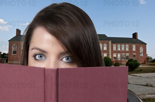 A beautiful young woman reading a book