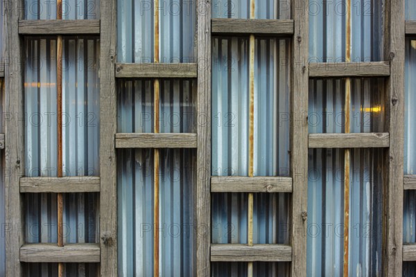 Wooden structure on the back of a metal fence