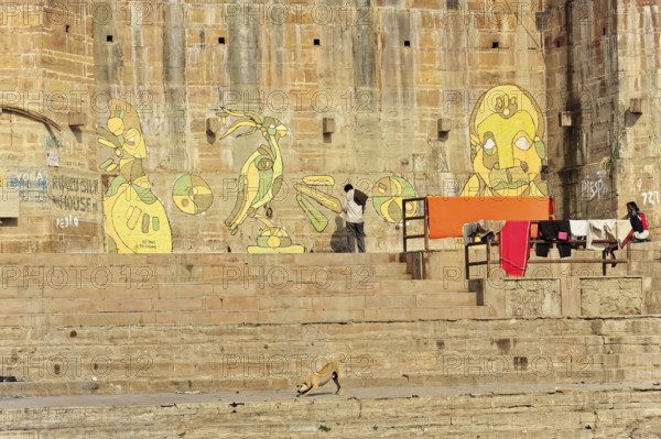 Varanasi, Uttar Pradesh, India, Asia, Wall paintings next to the steps of a Ganges Ghat with artistic figures, North India, Asia