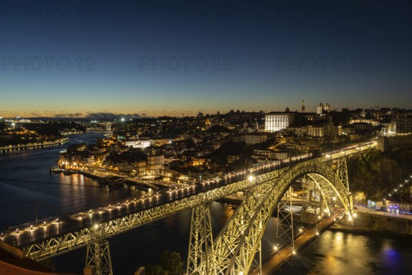 Illuminated Porto City, Douro River and Dom Luis bridge I at Night. View from Tourist Viewpoint Miradouro da Serra do Pilar. Portugal