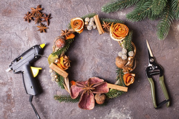 Christmas aromatic eco wreath with dry orange and anise stars, decorated tangerine peel roses, closeup details