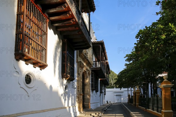 Side view to historic buildings in the Palace of Inquisition with artful woodwork and white facades, Cartagena, Unesco World Heritage