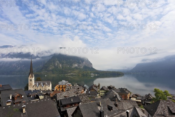 The most picturesque small town in Austria - Hallstatt. Slender bell tower and the church on the shore of Lake Hallstatt