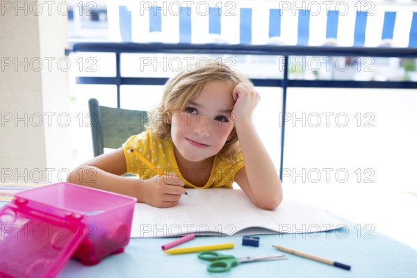 Child student kid girl bored with homework on desk table