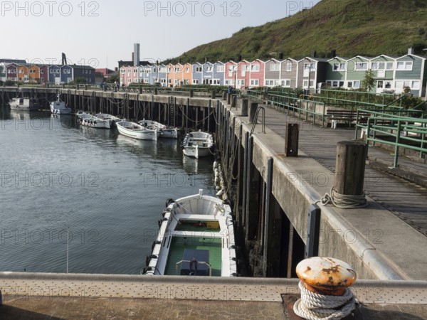 Small harbour with boats and colourful houses along a jetty, Heligoland, North Sea, Germany, Europe