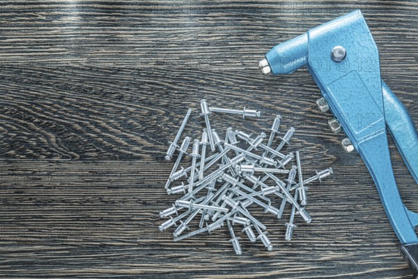 Riveting pliers stainless screws on wooden board