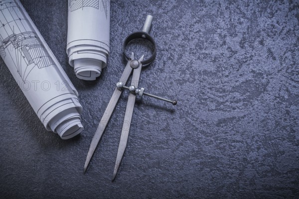 Construction plans pair of compasses on black background maintenance concept