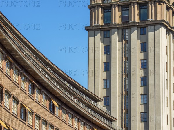 Modern building with a striking facade and a skyscraper in the background under a clear blue sky, stockholm, baltic sea, sweden, scandinavia