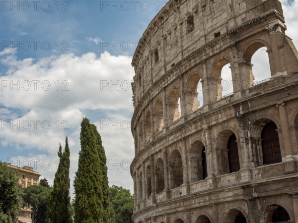 The historic Colloseum, an ancient Roman building with high arcades and cloudy skies, Rome, Italy, Europe