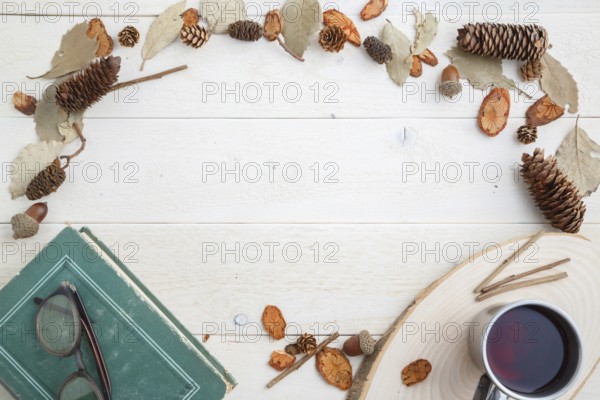 Vintage book and drink in retro mug on wooden background. top view with space for text