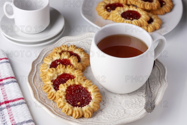 Cookies with jam and a cup of tea served for breakfast