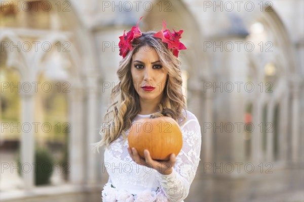 Portrait of fairy tale queen holding a pumpkin